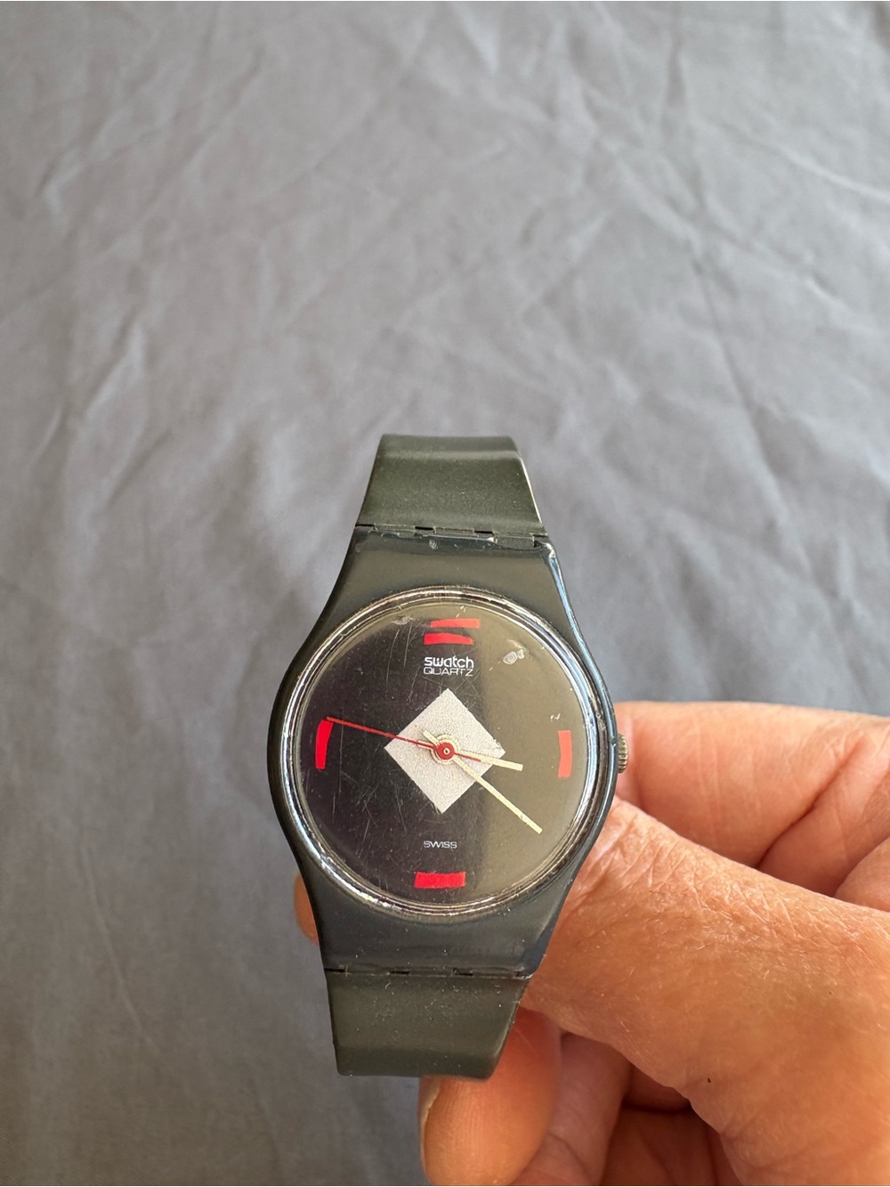Swatch Black Watch with Red Accents and White Dial Element